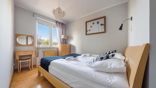 Posteľ alebo postele v izbe v ubytovaní Apartamenty Sun & Snow Legionów