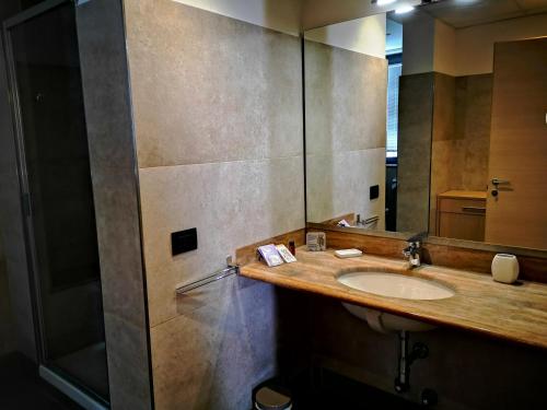 a bathroom with a sink and a mirror at ALBERGO BALDAZZI 1916 in Zavattarello