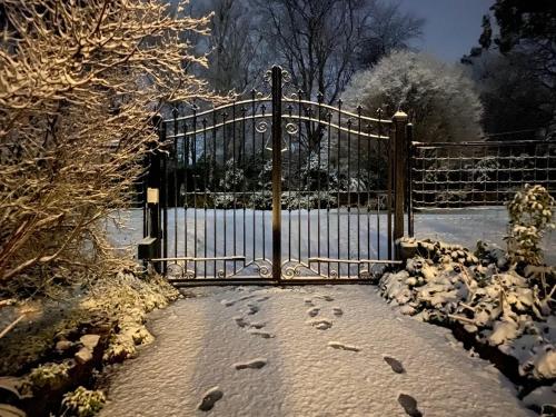 a metal gate with footprints in the snow at Belle Le Vie in Sassafras