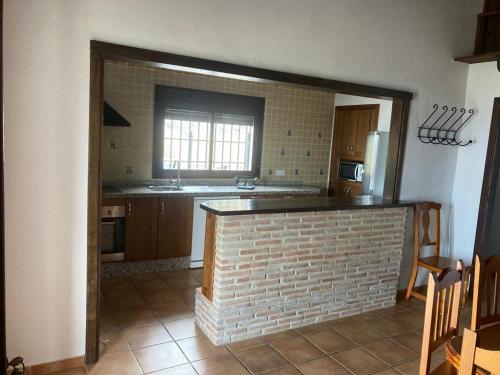 a kitchen with a brick fireplace in a room at Caminito del Rey , Álora Nice Views in Alora