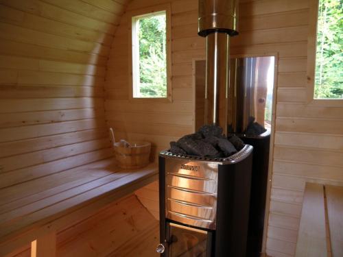 a room with a stove in a wooden cabin at Słoneczna Polana in Solina