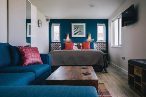 a living room with a bed and a couch at Gwel an Mor in Portreath