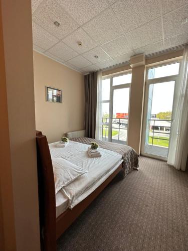 - une chambre avec un lit et une grande fenêtre dans l'établissement Riga Unimars Hotel, à Riga