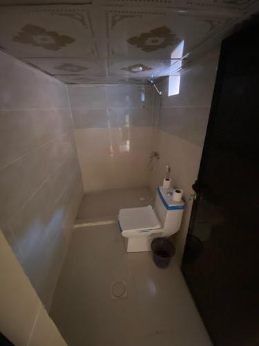 a small bathroom with a toilet in a room at Wadi Rum Desert Base Camp in Wadi Rum