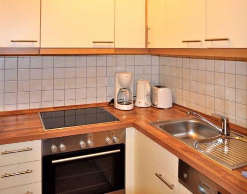 a kitchen with a sink and a counter top at Landhaus zum Strande - 44-6 1 in Kägsdorf