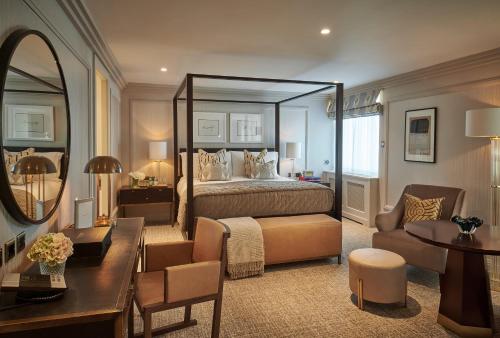 a hotel room with a bed and a mirror at The Westbury Hotel in Dublin