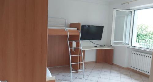 a room with a desk with a computer and a bunk bed at Cà Delmo in Massa