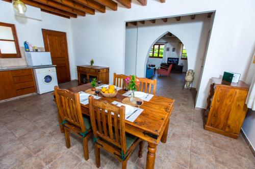 a kitchen and dining room with a wooden table and chairs at Villa Pomos Med. in Pomos