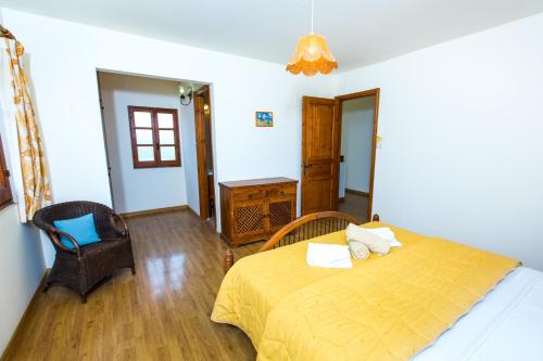 a bedroom with a bed and a chair in it at Villa Pomos Med. in Pomos