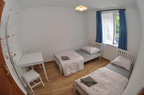 a small room with two beds and a window at Slavonice - Maříž in Maříž