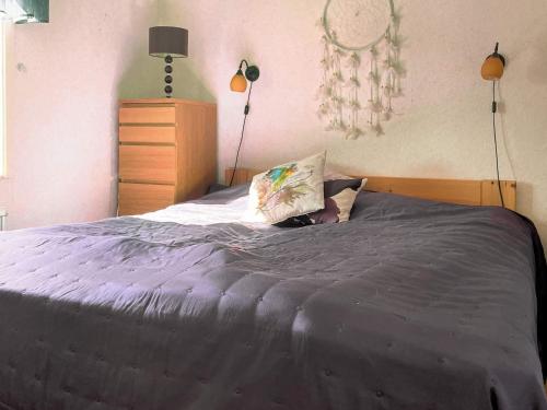 a woman laying on a bed with a pillow at Holiday home HJO IV in Hjo