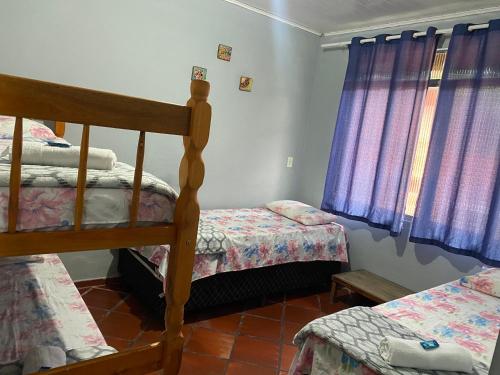 Un pat sau paturi într-o cameră la Pousada do colono