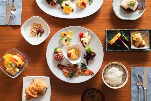 a wooden table with plates of food on it at hotel kanra kyoto in Kyoto