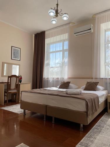 a bedroom with a large bed in front of a window at Belon Land in Astana