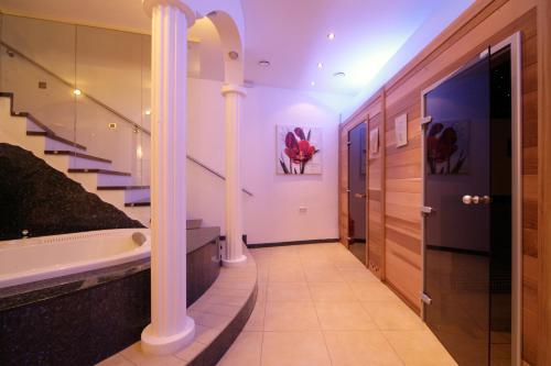 a bathroom with a bath tub and a staircase at Landhotel Moshammer in Waidhofen an der Ybbs