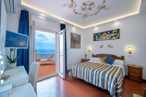 a bedroom with a bed and a balcony at Villa Briganti Seaview Terrace in Positano