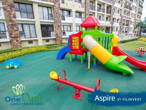 a playground in front of a apartment building at MQ Staycation at One Oasis in Cagayan de Oro