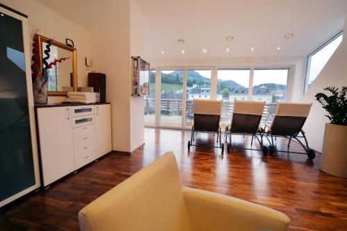 a living room with a couch and a table and chairs at Landhotel Moshammer in Waidhofen an der Ybbs