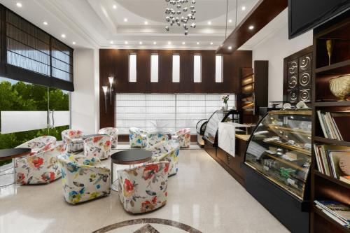 a lobby with chairs and a table and a store at Inn Riviera Jammu in Jammu