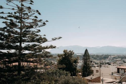 a view of a city with a pine tree at Glamorous Studio near Center in Heraklio Town