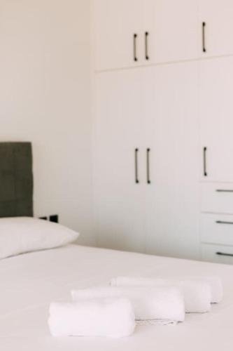 a bedroom with a white bed with white cabinets at Glamorous Studio near Center in Heraklio Town