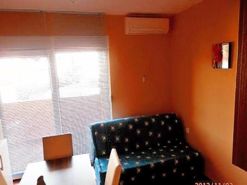a living room with a couch and a table and a window at Apartments St Rialto in Jelsa