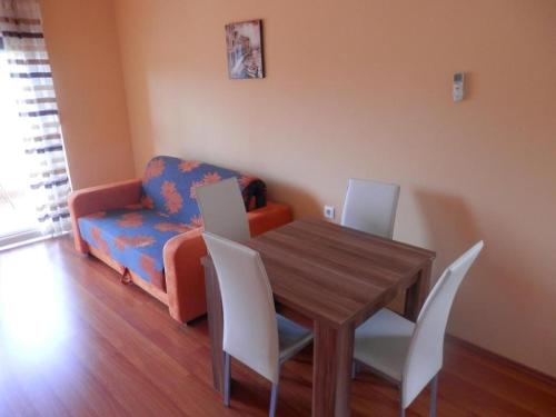 a dining room with a table and chairs and a couch at Apartments St Rialto in Jelsa