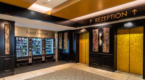 a hotel lobby with a food market sign on the wall at PLAZA Premium Timmendorfer Strand in Timmendorfer Strand