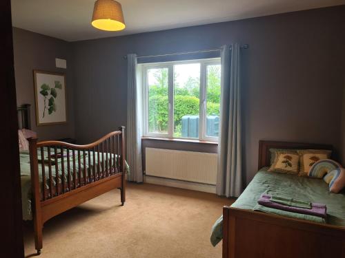 a bedroom with a crib and a window at Lakeview Retreat 