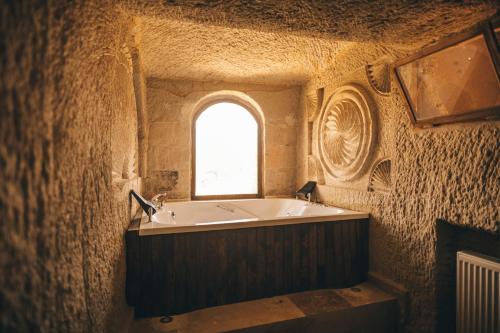 a bath tub in a room with a window at Wonder of cappadocia in Goreme