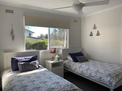 a bedroom with two beds and a window at Bayview Hideaway in Point Lonsdale