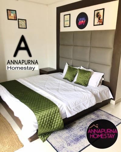 a bedroom with a large bed with green pillows at Annapurna Homestay in Chālsa