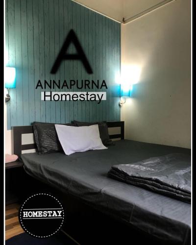 a bed in a room with a sign on the wall at Annapurna Homestay in Chālsa