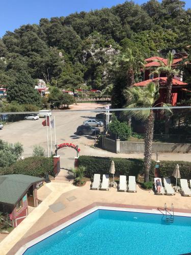 a swimming pool at a resort with a parking lot at Grand Aquarium in Marmaris