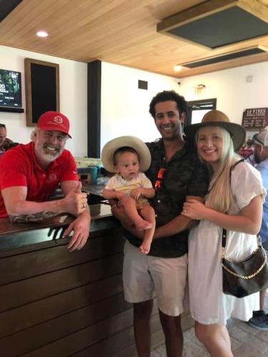 a group of people standing in a kitchen with a baby at 12 Fires Luxury Glamping #2 in Johnson City
