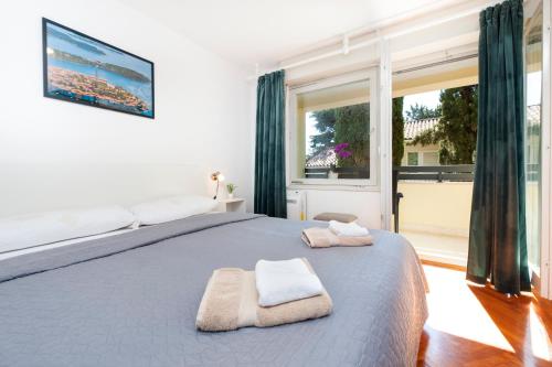 a bedroom with a large bed with towels on it at Casa Caterina by Irundo in Rovinj