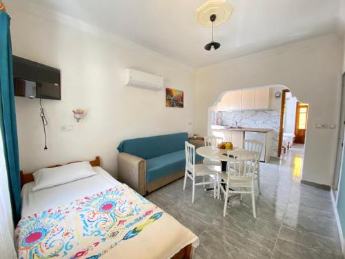a bedroom with a bed and a table and chairs at Hotel Sema in Patara