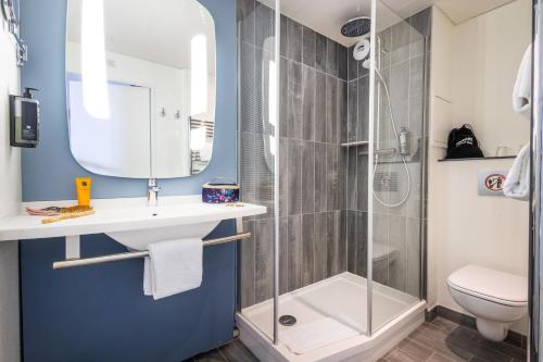 a bathroom with a shower and a sink and a toilet at ibis Saint Malo Plage in Saint Malo
