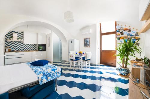 a living room with a blue and white floor at Appartamento luminoso e romantico ANyMA in Massa Lubrense