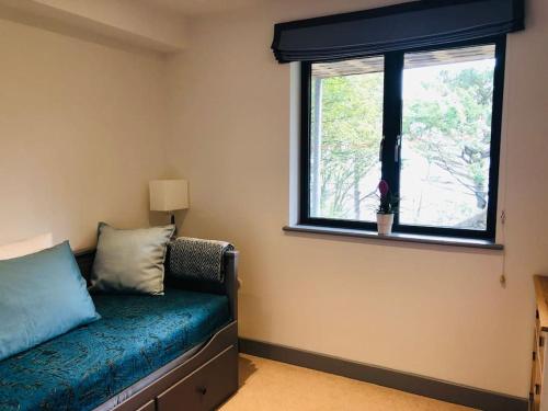 a room with a couch and a window at Sea Cliff View Designer Home in Lyme Regis