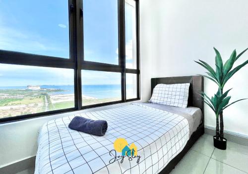 a bedroom with a bed and a large window at Bali Residence I B3105 Luxury 2BR I Seaview I 6-9pax l WaterPark I CityCentre by Jay Stay in Melaka