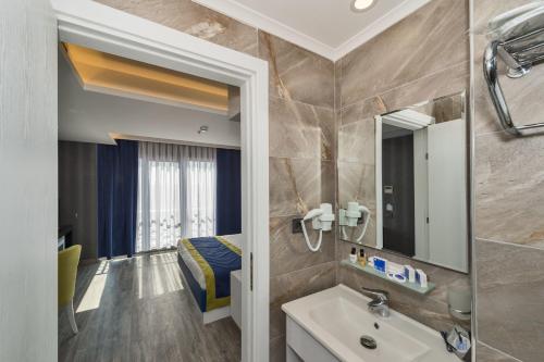 a bathroom with a sink and a mirror at Inntel Hotel Istanbul in Istanbul