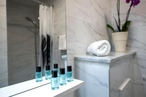 a bathroom with a counter with several bottles of cosmetics at Casa Caterina by Irundo in Rovinj