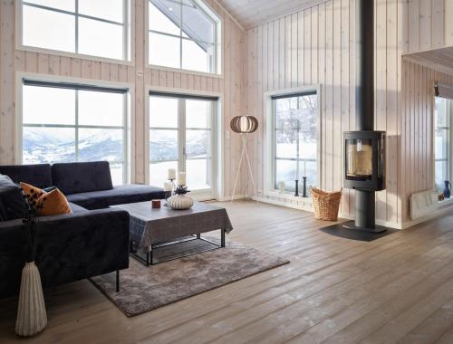 a living room with a couch and a fireplace at Panorama View in Stranda