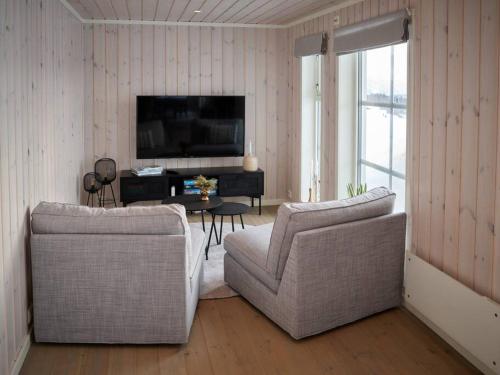 a living room with two chairs and a television at Panorama View in Stranda