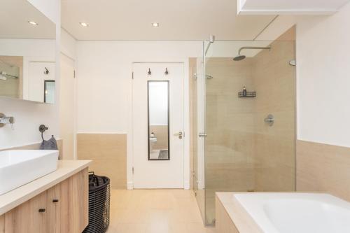 ein Bad mit einer Dusche und einem Waschbecken in der Unterkunft Edgy On Bree in Kapstadt