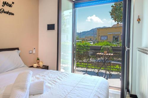 a bedroom with a bed and a view of a balcony at B&B Studio83 Pompei in Pompei