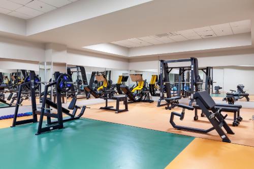 a gym with treadmills and elliptical machines at Acapulco Resort Hotel in Kérynia