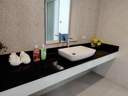 a bathroom with a sink and a mirror at E villa , private pool villa for your family in Hua Hin