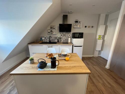 a kitchen with a wooden counter top in a room at STUDIO SCANDINAVE - HYPER CENTRE LORIENT in Lorient